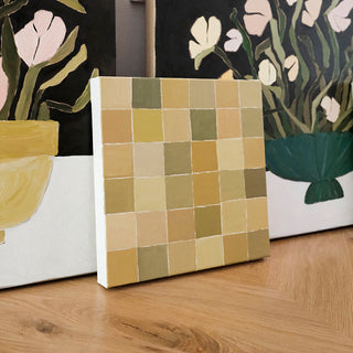 Original abstract oil painting titled Fly Over by Alex King featuring a geometric grid of hand-painted squares in olive green, ochre, cream, and golden earth tones inspired by an aerial view of farmland.