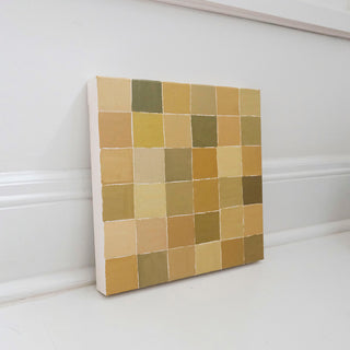 Original abstract oil painting titled Fly Over by Alex King featuring a geometric grid of hand-painted squares in olive green, ochre, cream, and golden earth tones inspired by an aerial view of farmland.