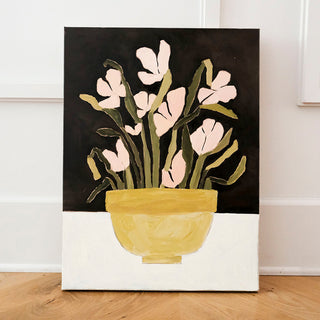 Original oil painting titled Fresh Cuts by Alex King featuring blush pink flowers with green stems arranged in a yellow ceramic bowl against a black background in a contemporary floral still life.